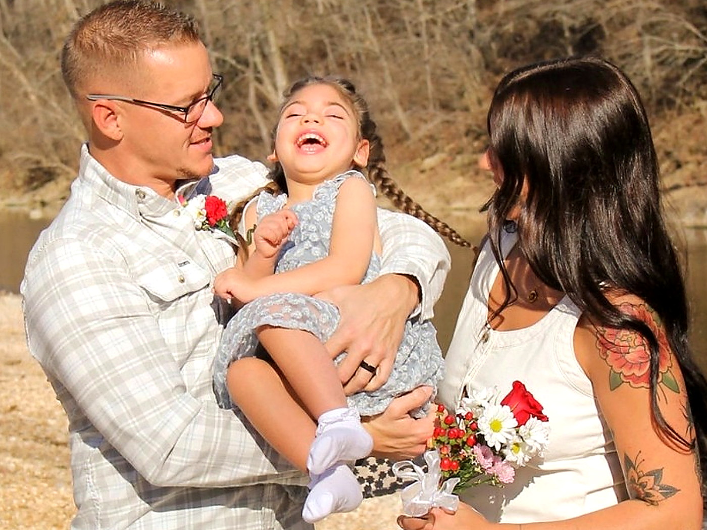 Travis, Madison, and Ivy laughing together by the creek