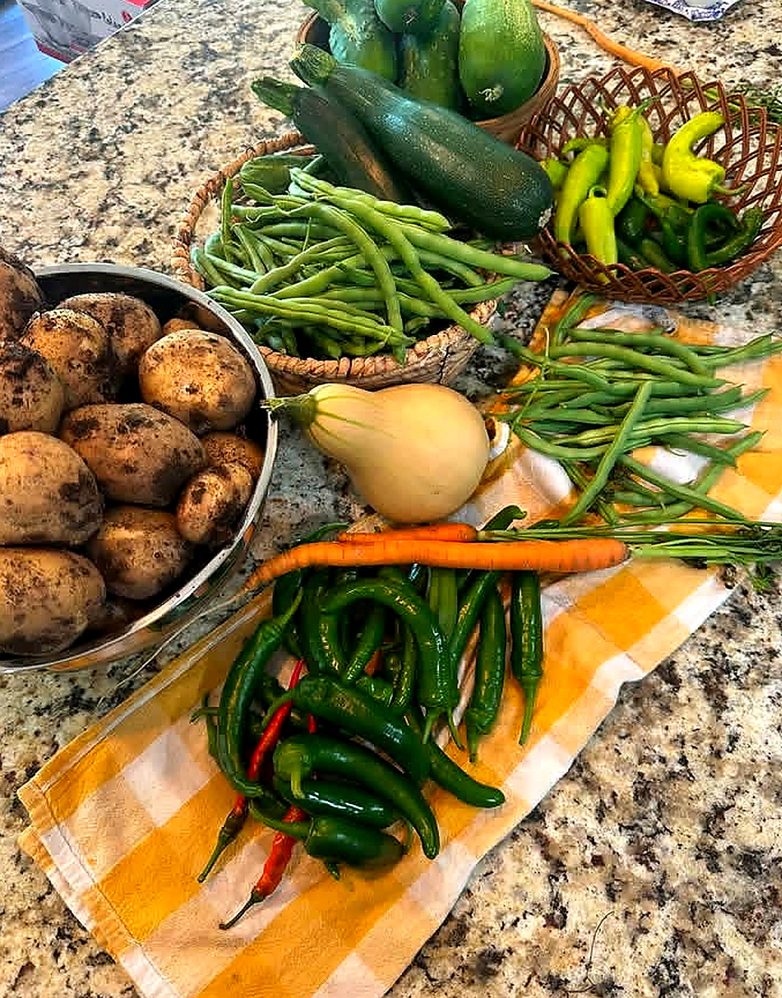 Fresh garden produce and farm eggs gathered on the kitchen counter